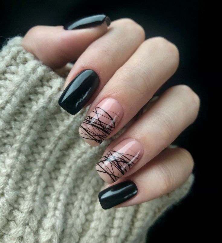 Chic Black and Nude Nail Design with Artistic Accent Patterns