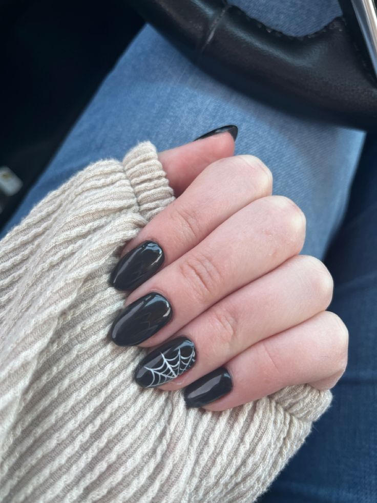 Spooky-Chic: Elegant Black Manicure with Spider Web Design.