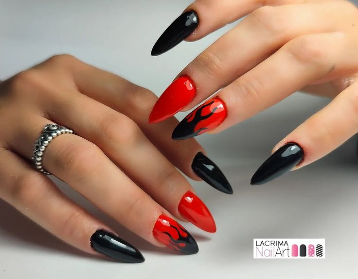 Dramatic Red and Black Stiletto Nail Design with Edgy Flame Patterns.