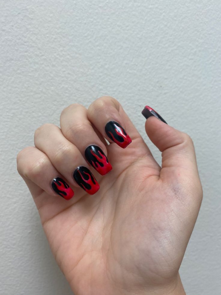 Edgy Flame-Inspired Nail Design with Glossy Red and Black Hues