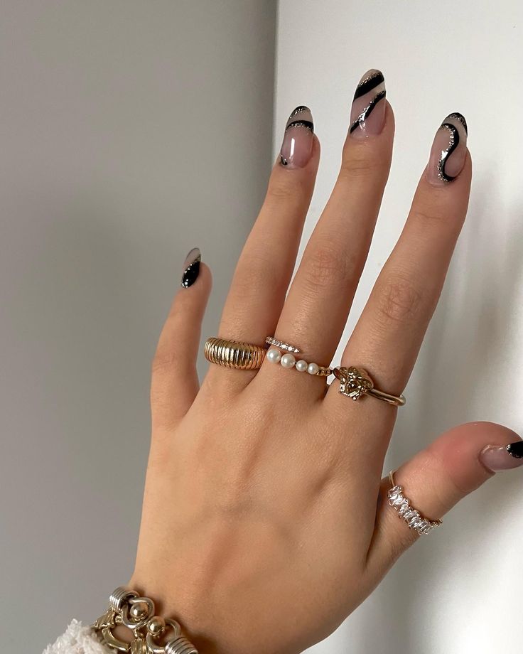 Chic Nude and Black Nail Design with Wavy Lines and Elegant Embellishments