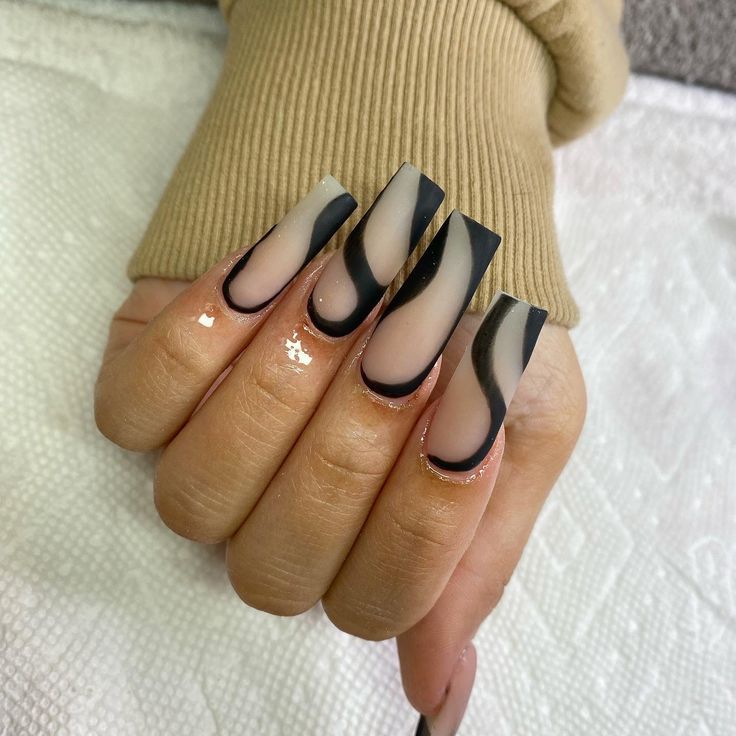 Elegant Long Nails with Translucent and Opaque Finishes, Featuring Striking Black Swirls and Shimmer Accents.