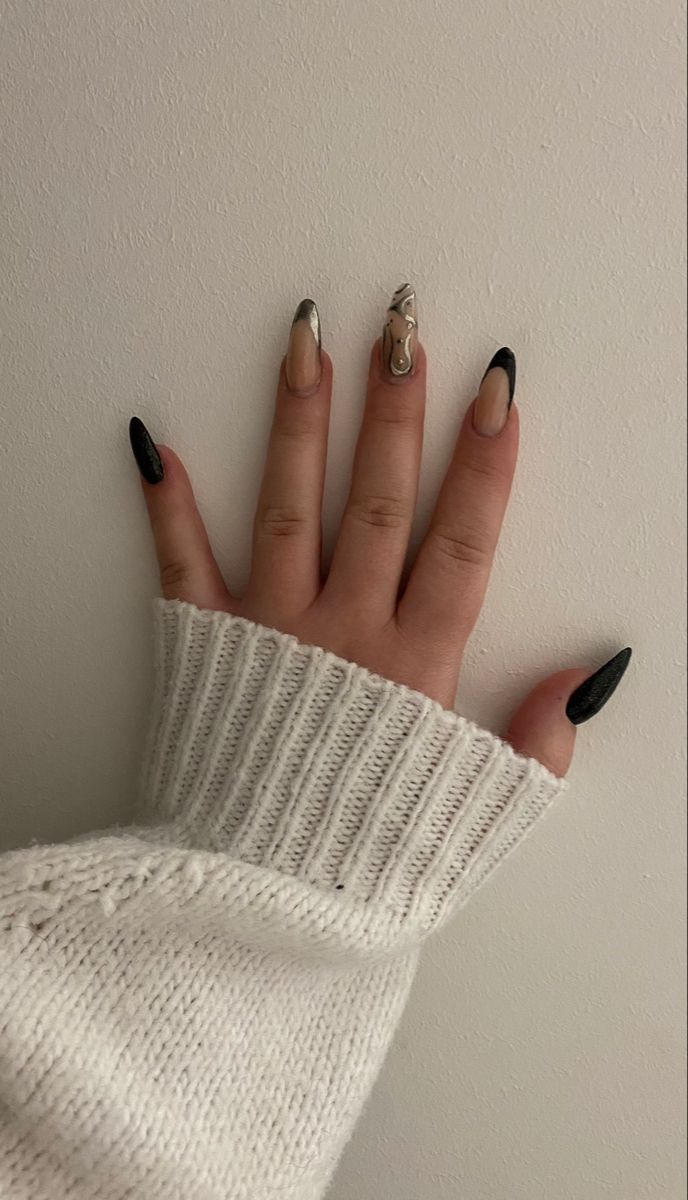 Chic Almond-Shaped Nail Design: Bold Black and Nude Contrast with Unique Swirling Accents.