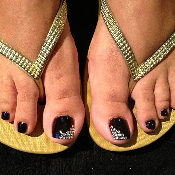 Chic Summer Pedicure: Deep Navy with Sparkling Silver Accents and Elegant Flip-Flops.