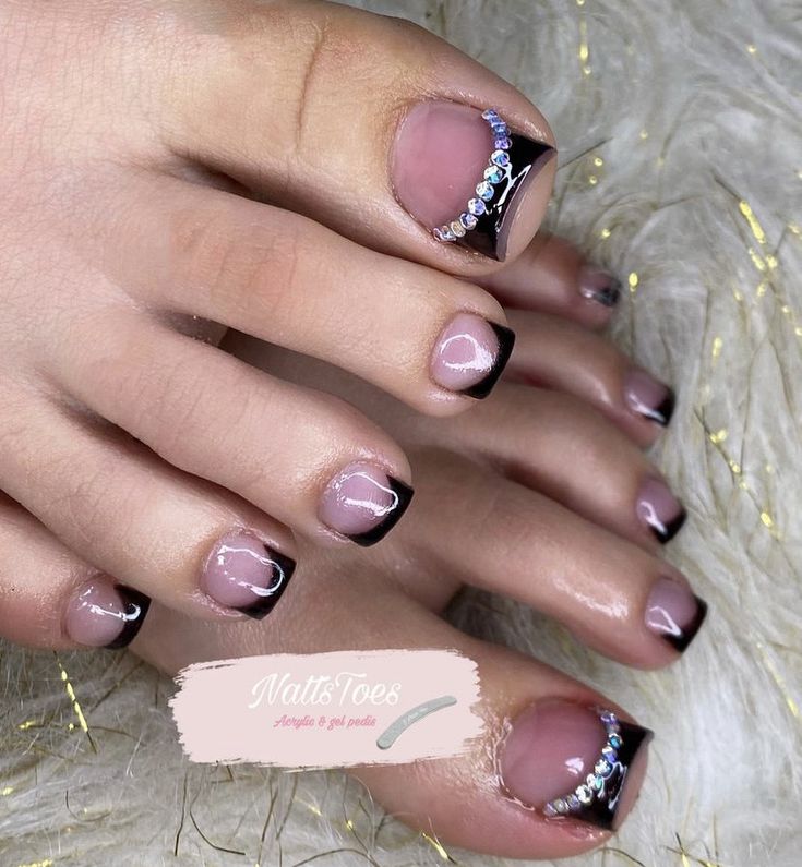 Chic Nude and Black Elegant Nail Design with Rhinestone Accents.