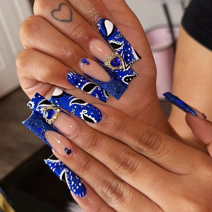 Bold Vibrant Blue Nail Design with Glamorous Embellishments i Textural Contrast.