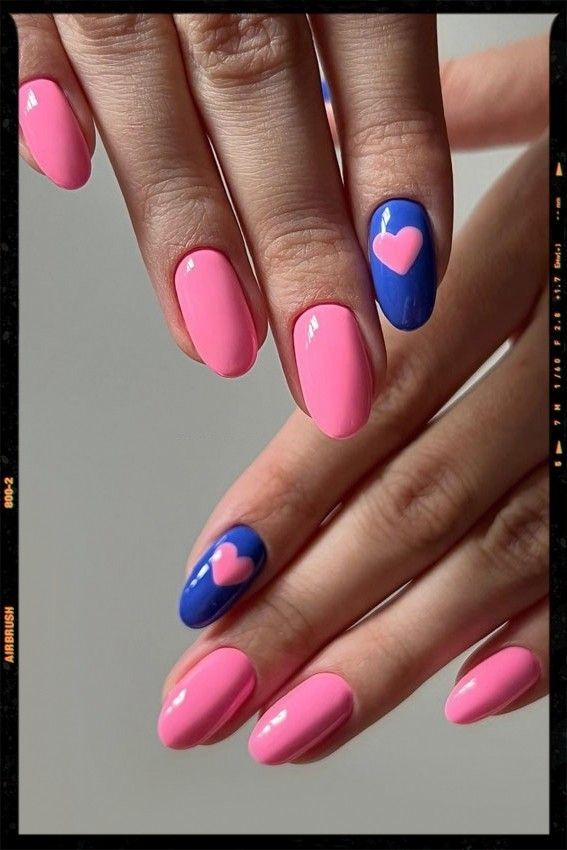 Playful Pink and Blue Heart Motif Nail Design for Creative Expression.