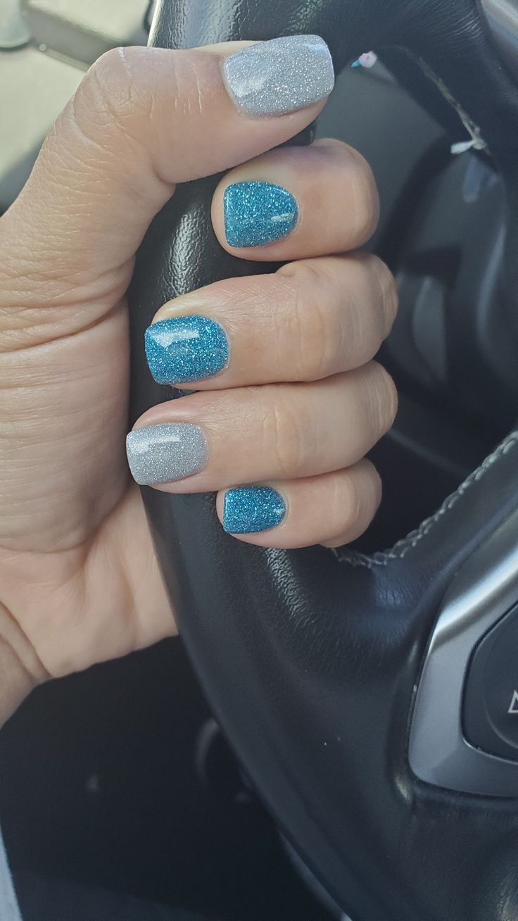 Elegant Blue and Silver Glittery Nail Design for a Playful Statement.