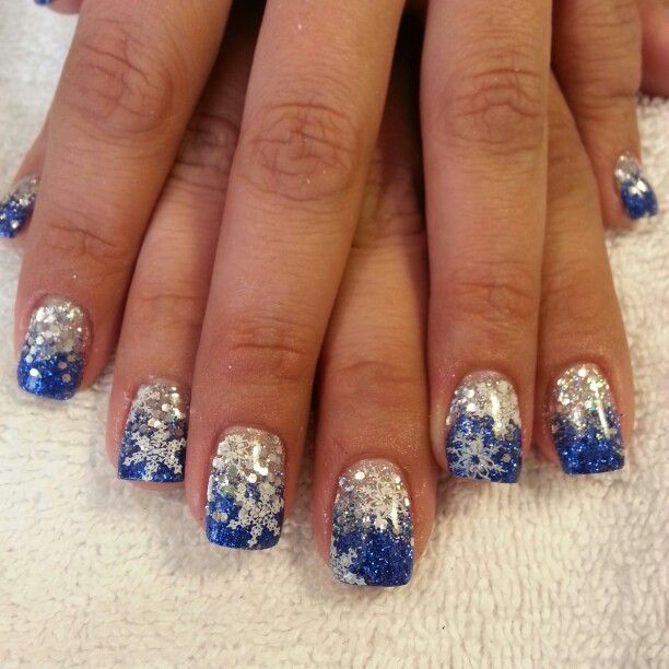 Winter-Inspired Nail Art: Glittering Blue and Silver Gradient with Whimsical Snowflake Patterns