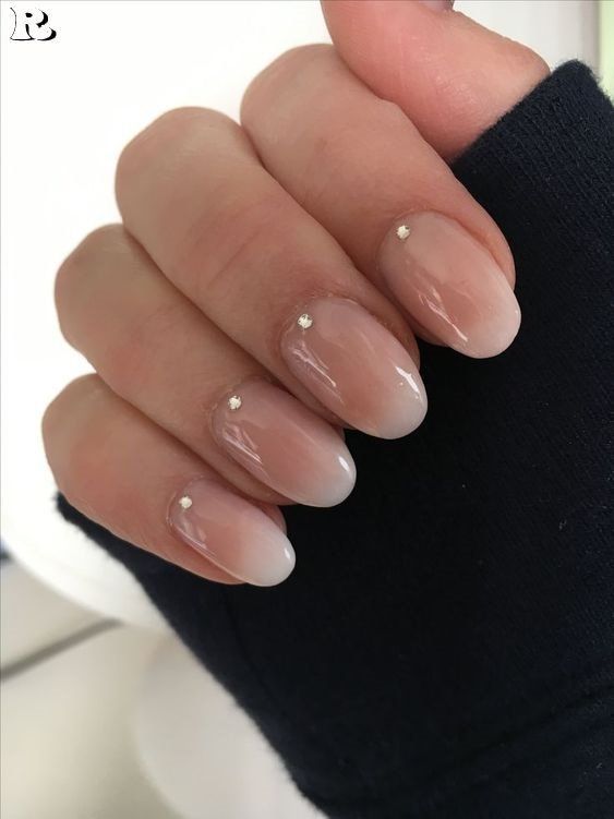 Sophisticated Ombre Nails with Silver Stud Accents for Any Occasion.