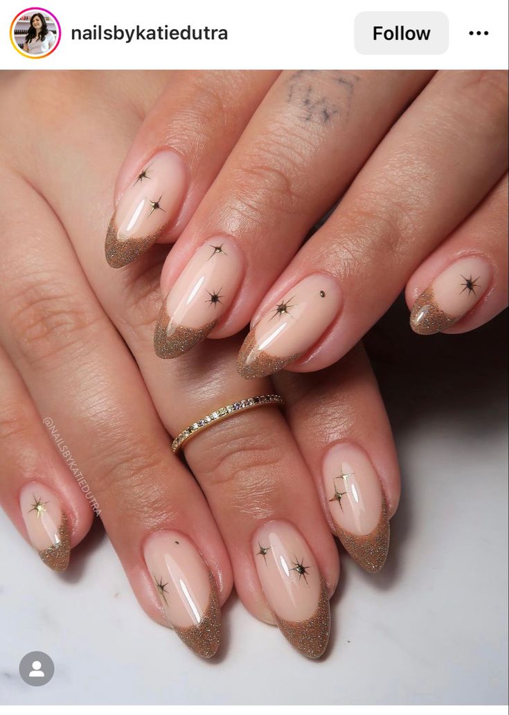 Celestial Elegance: Nude and Glittery Gold Nail Design with Star Accents