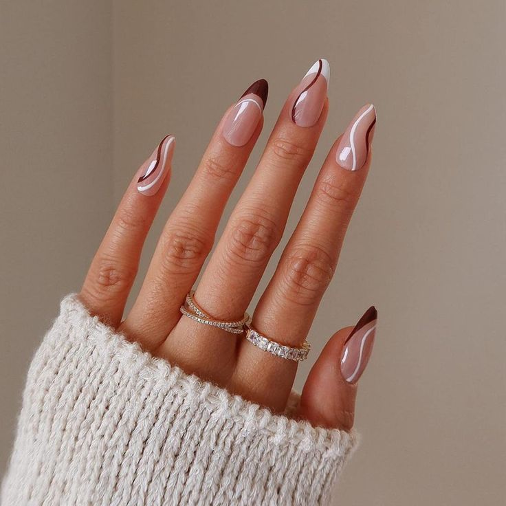 Chic Modern Nail Design: Soft Pink and Rich Brown with Distinctive Swirls