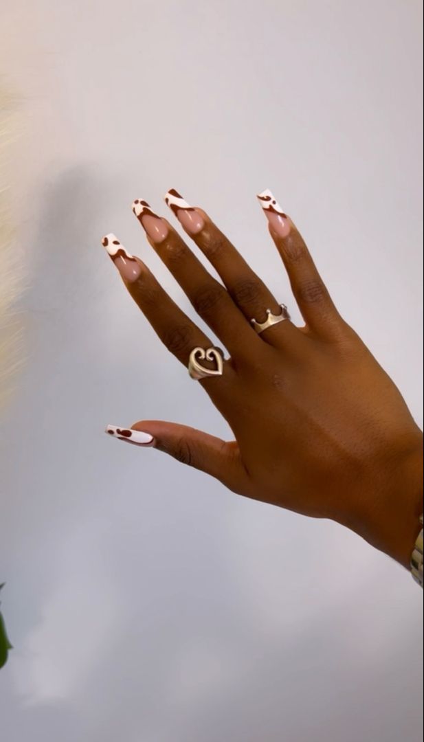 Chic Nude and White Nail Design with Playful Red Tips for a Fashionable Statement.