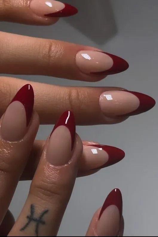 Chic Almond-Shaped Nails: Nude Base with Bold Red Tips for Elegant Glamour.