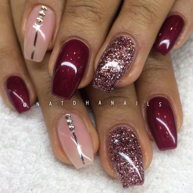 Sophisticated Elegant Nail Design: Deep Burgundy and Soft Nude with Glitter Accents and Metallic Details.