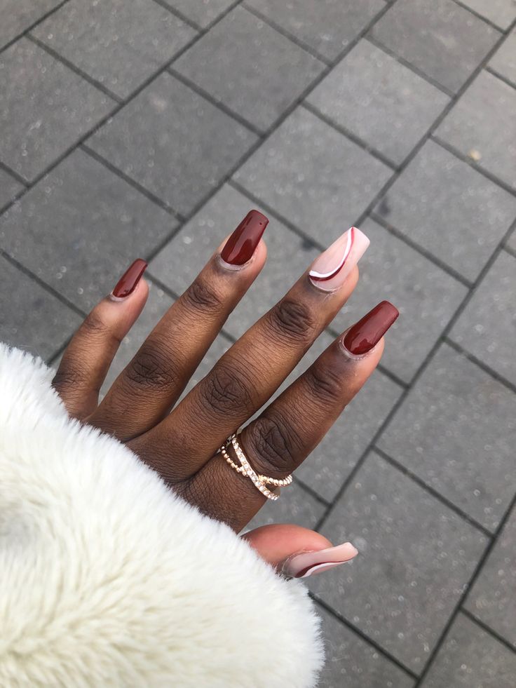 Elegant Deep Burgundy Nail Design with Soft Nude Accent and Minimalist Ring.