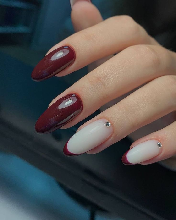 Chic Almond-Shaped Nail Design: Deep Burgundy Tips on Crisp White Base with Sparkling Gem Accents