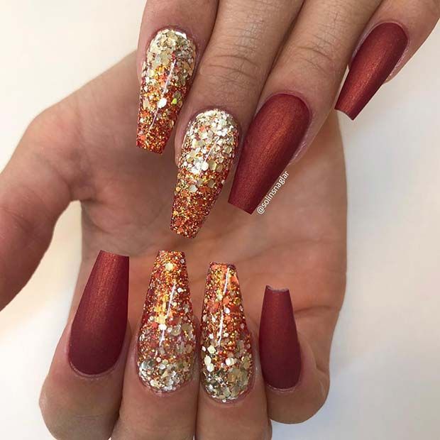 Elegant Matte and Glitter Nail Design in Rich Reds with Glamorous Gold Accents.