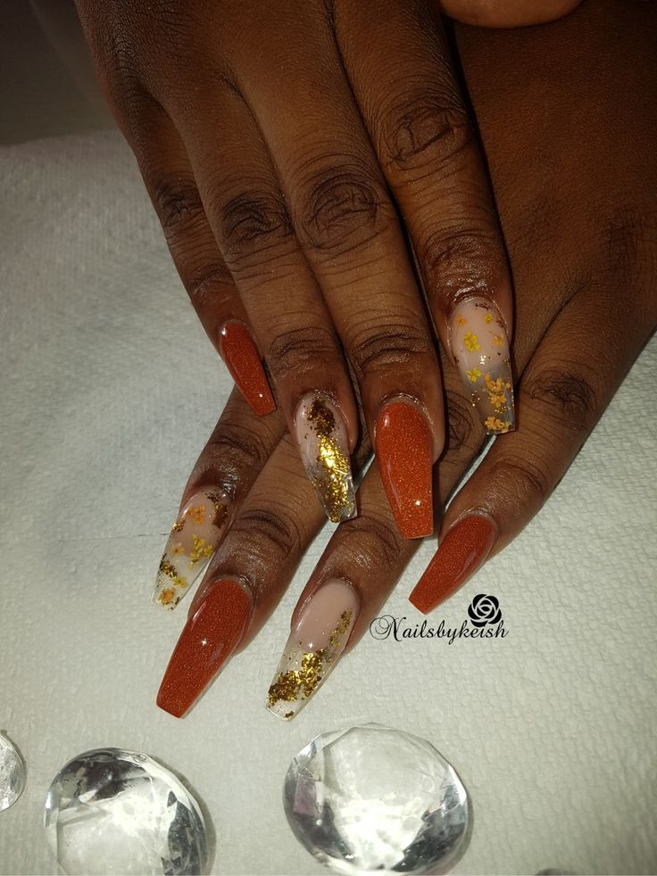 Stylish Terracotta Ombre Nails with Glamorous Gold Glitter Accents.