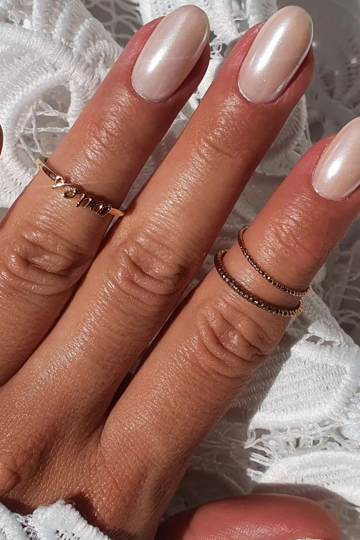 Chic Nude Nail Design with Subtle Shine and Delicate Gold Accents.