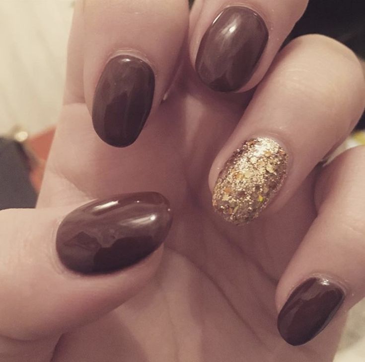 Chic Deep Brown Nail Design with Glamorous Gold Glitter Accent.