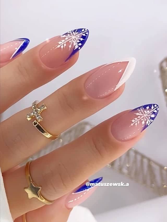 Chic Winter-Inspired Nail Design: Nude Tones with Snowflake Patterns and French Tips.