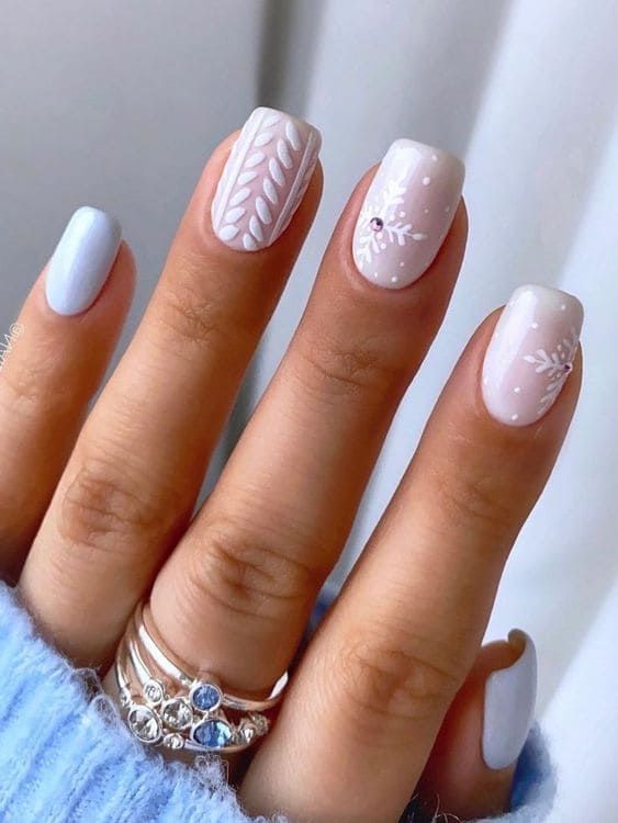 Elegant Pastel Nail Design with Floral Patterns and Mixed Finishes.