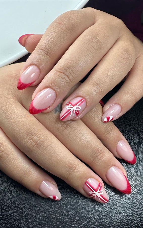 Chic Festive Nail Design: Elegant Soft Pink and Vibrant Red with Playful White Accents.