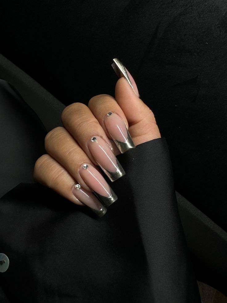 Chic Transparent Nails with Metallic Tips and Dainty Embellishments for Modern Elegance.