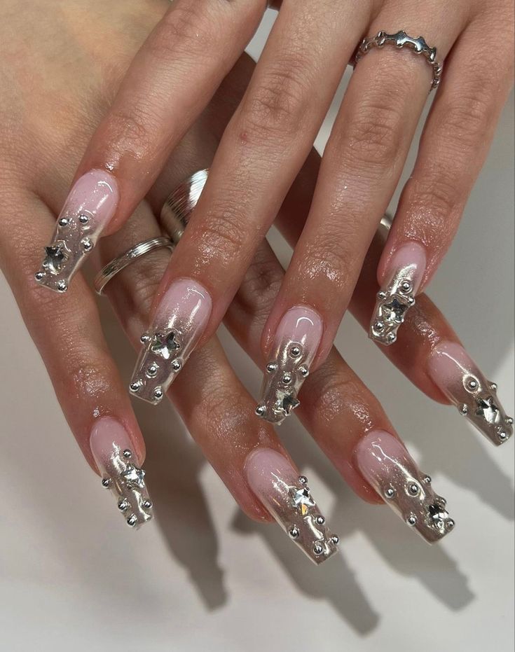 Elegant Gradient Pink Nail Design with Sparkling Embellishments for a Bold Look.