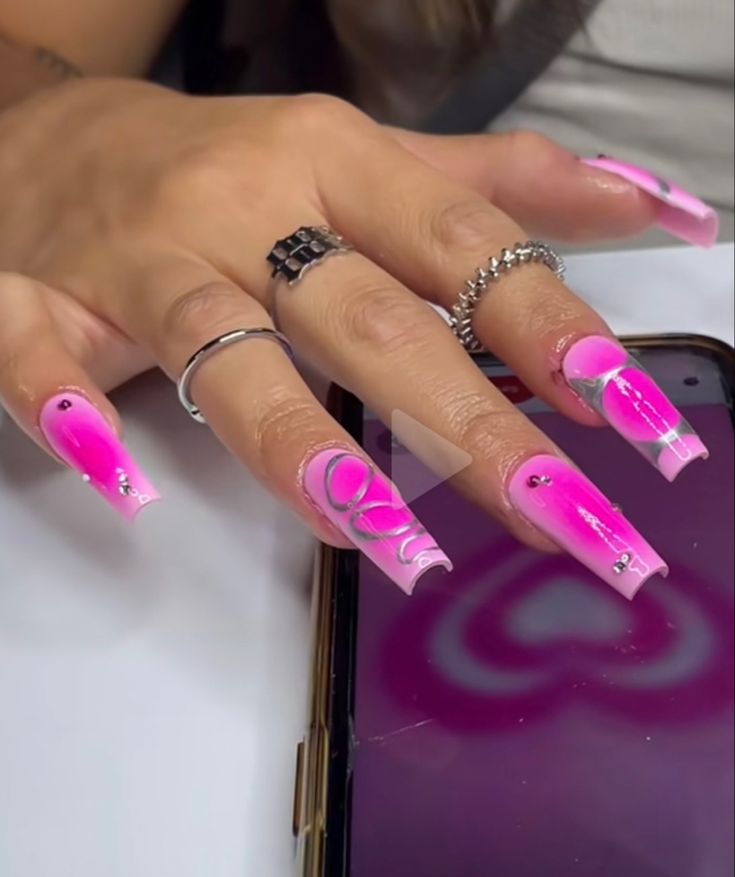 Glamorous Gradient Pink Acrylic Nails with Silver Accents and Rhinestones.