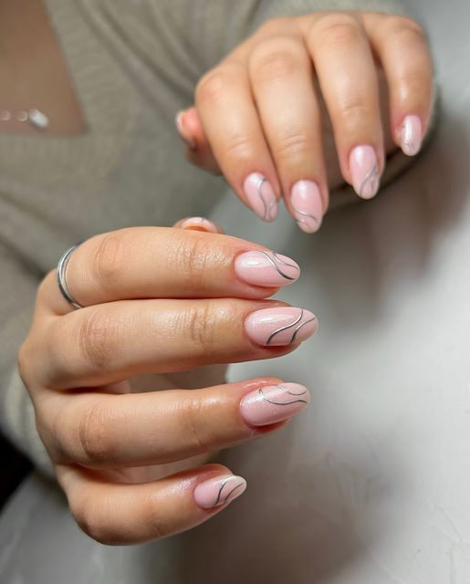 Chic Sophistication: Soft Pink Nail Design with Delicate Black Accents