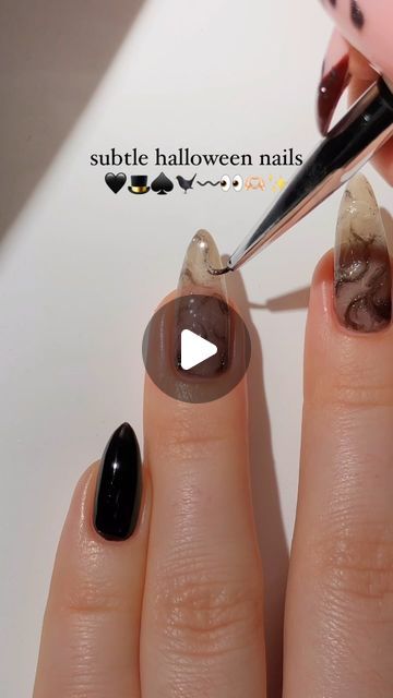 Chic Subtle Halloween Nail Design with Elegant Marble Effect and Playful Accents