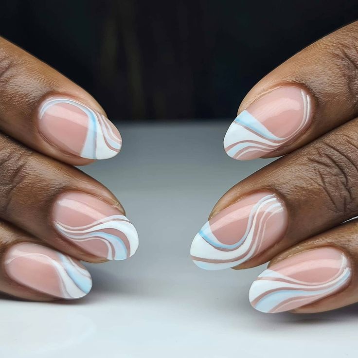 Sophisticated Almond-Shaped Nail Design with Soft Pink Base and Fluid White-Blue Swirls.