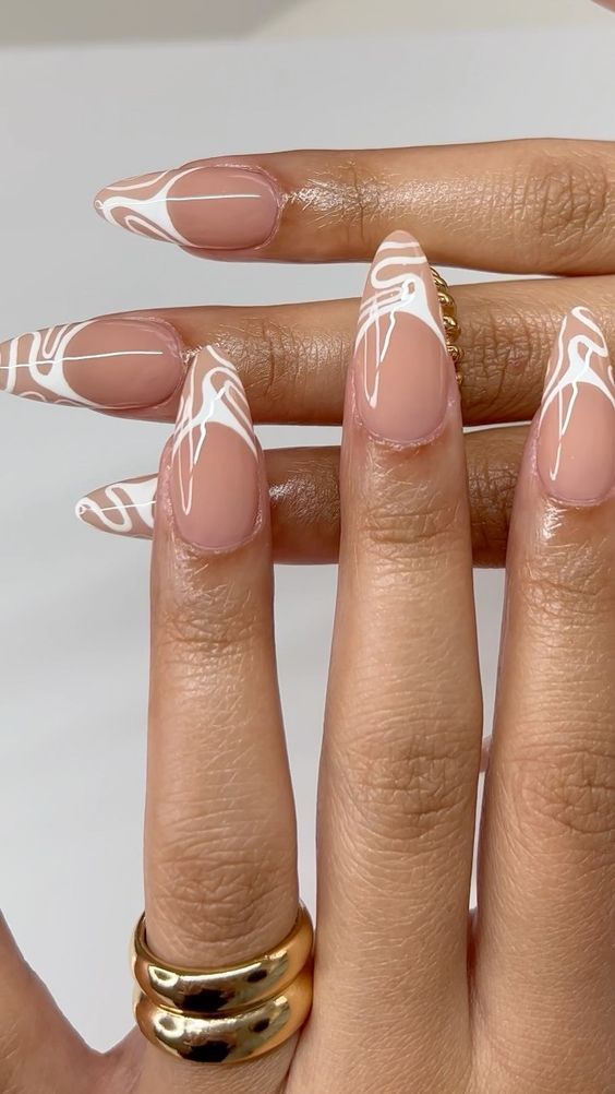 Chic Almond-Shaped Nail Design with Nude Base and Artistic White Swirls