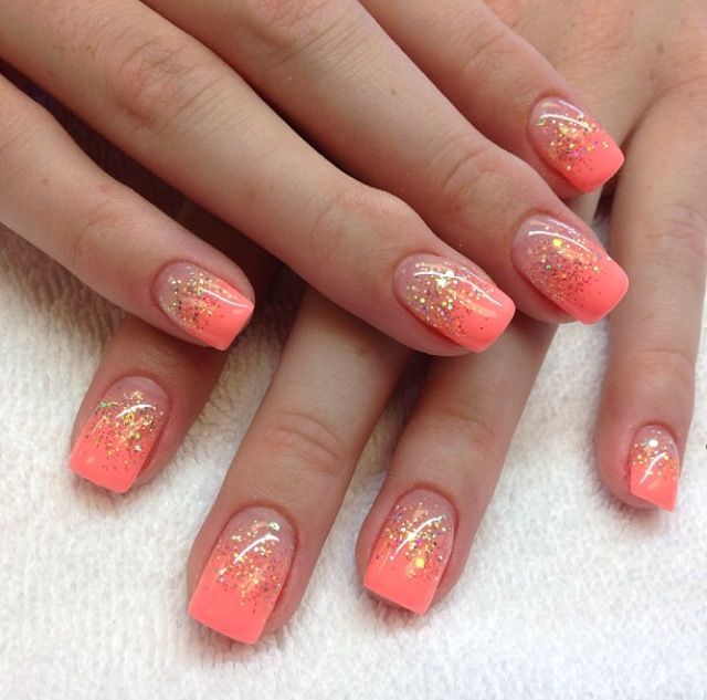 Elegant Ombre Nail Design: Soft Coral to Vibrant Peach with Gold Glitter Accents