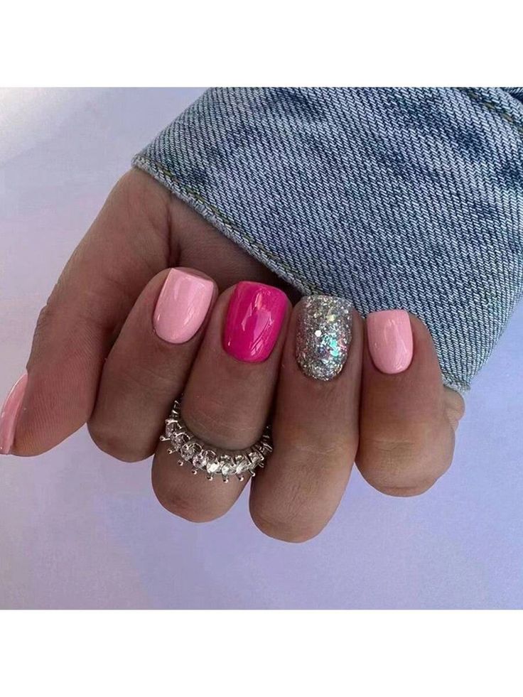 Chic Colorful Nail Design with Pastel Pink, Vibrant Accent, and Sparkling Silver Glitter.