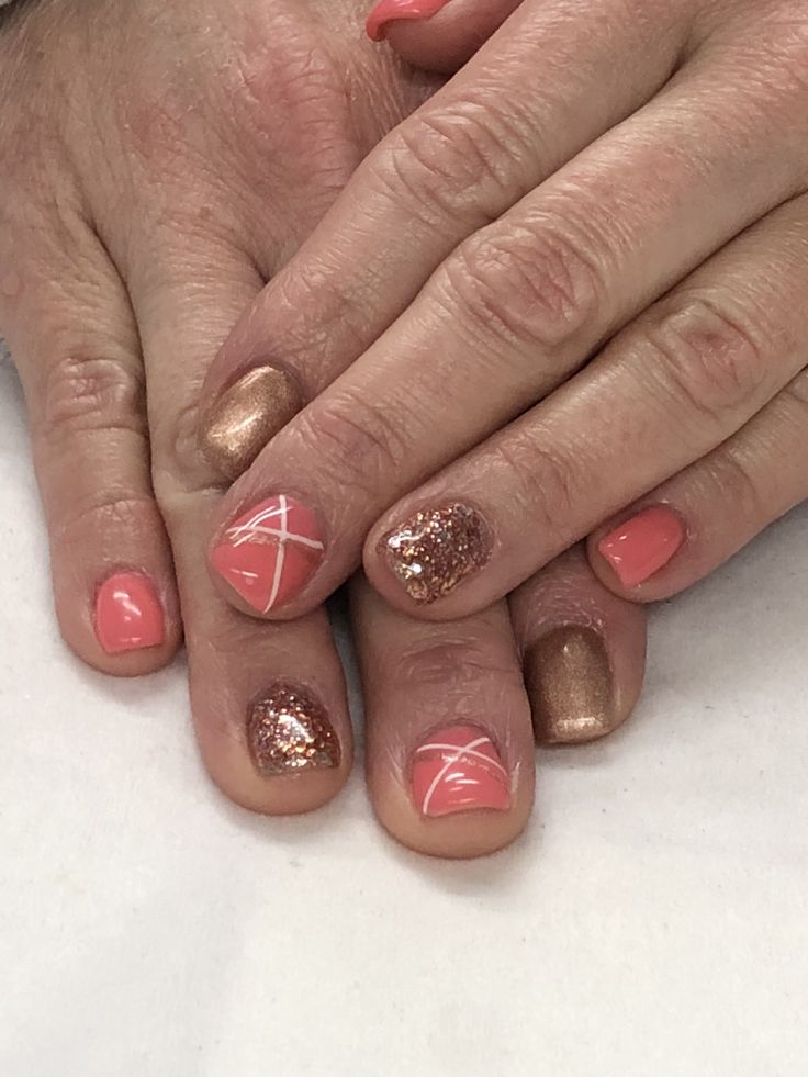 Stunning Coral and Metallic Nail Design with Geometric Accents.