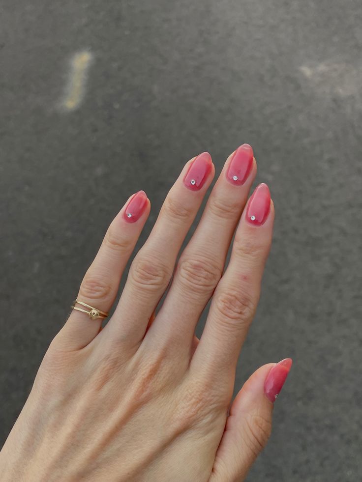 Elegant Nail Design with Soft Pink Polish and Glamorous Accent Stones for Any Occasion