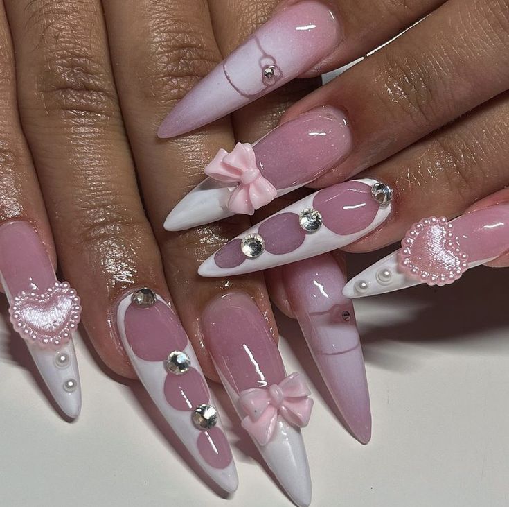 Chic Pink Nail Design with Bows, Hearts, and Rhinestones for a Playful Elegance.