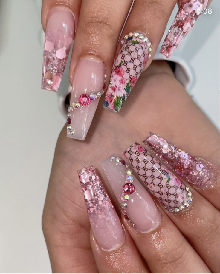 Elegant Sparkling Pink Nail Design with Floral Patterns and Gemstone Embellishments