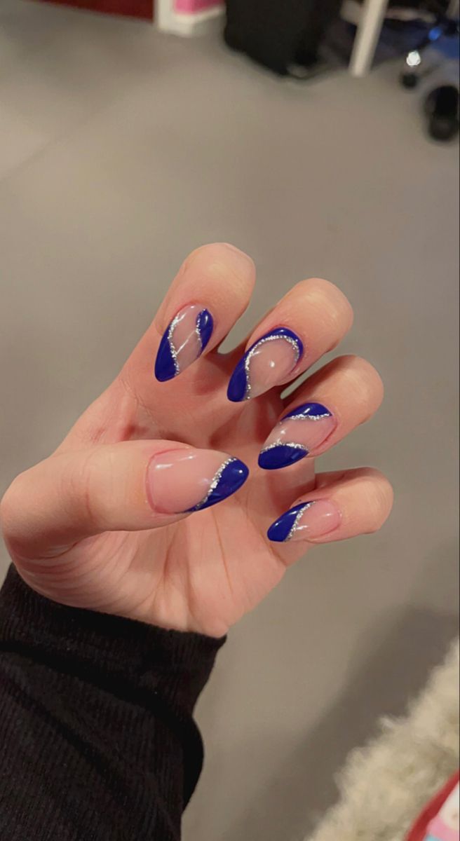 Elegant Bold Blue Nail Design with Intricate Silver Patterns and Unique Geometric-Organic Elements