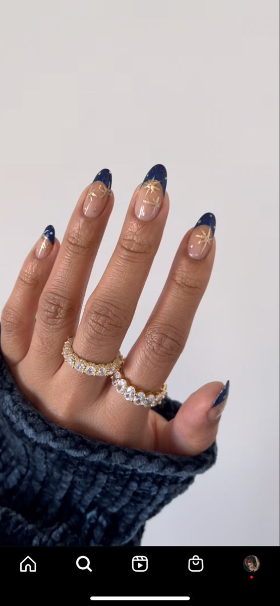 Chic Navy Blue French Tip Nail Design with Sheer Nude Base and Golden Star Accents