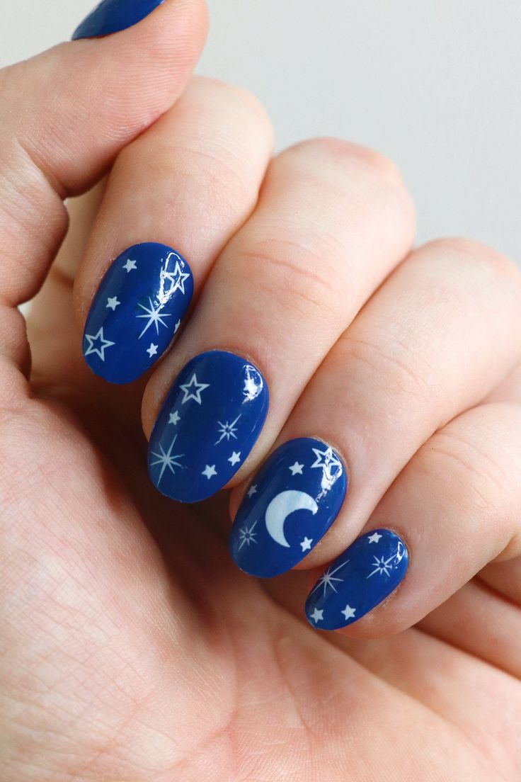 Whimsical Celestial Nail Art with Deep Blue Base, Stars, and Crescent Moon.