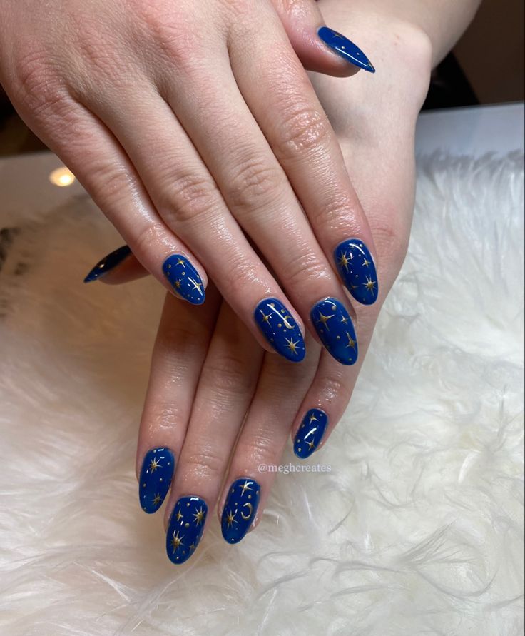 Celestial-Inspired Nail Design: Elegant Blue Base with Golden Star Patterns