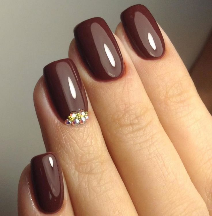 Sophisticated Burgundy Nails with Glossy Finish and Multicolored Rhinestone Accent.