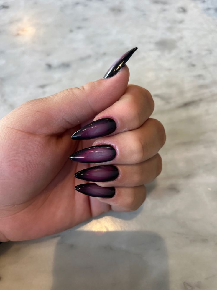 Elegant Ombre Nail Design with Pointed Tips: Deep Purple to Shining Black Gradient.