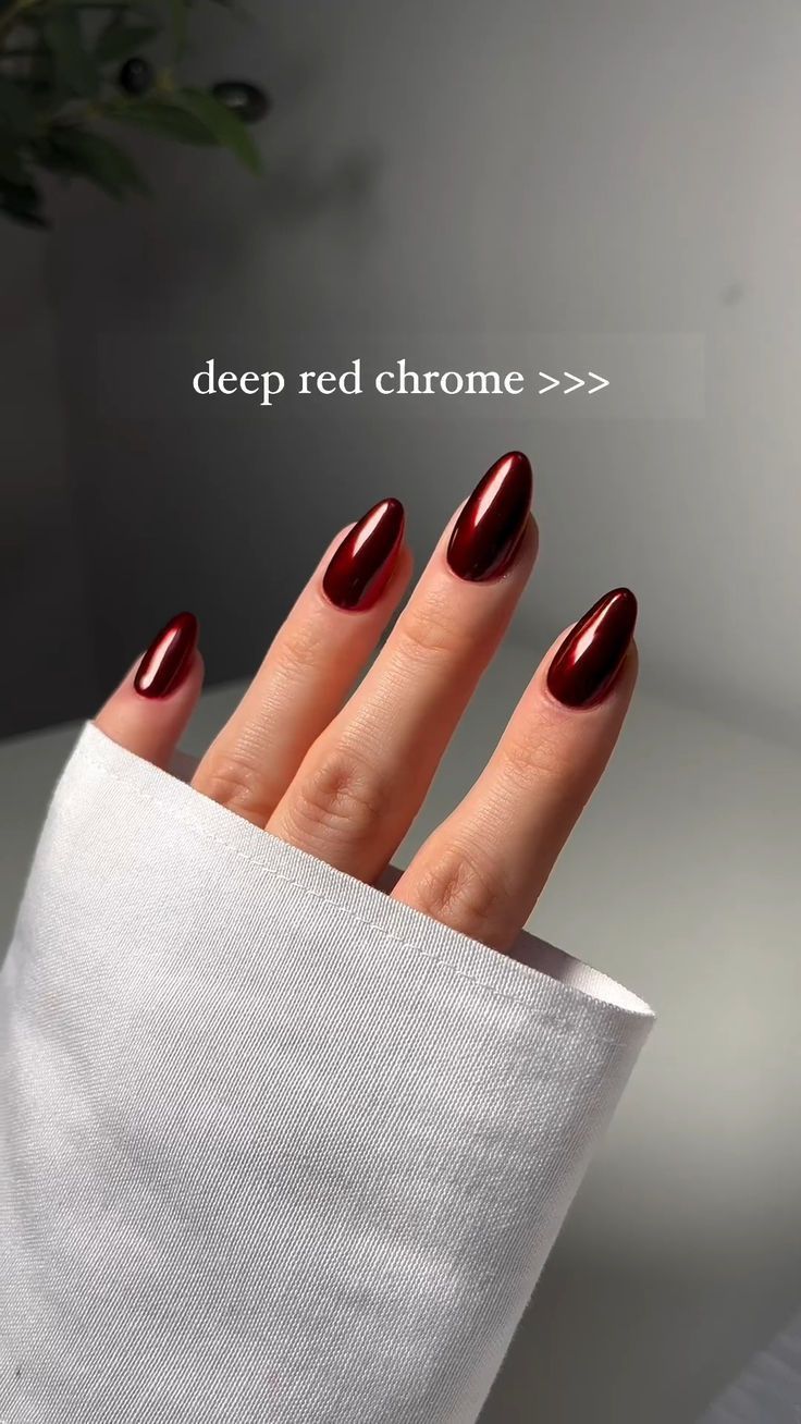 Exquisite Deep Red Chrome Nails: A Luxurious and Bold Statement in Almond Shape.