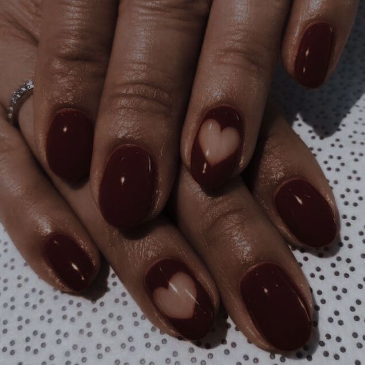 Chic Romantic Red Nail Design with Heart-Inspired Accent Nails for Special Occasions.