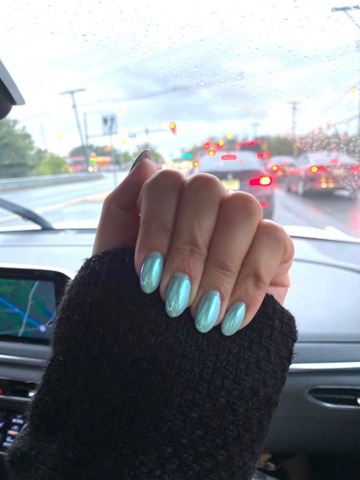 Elegant Mint Green Glossy Nails: A Modern Statement in Oval Design.